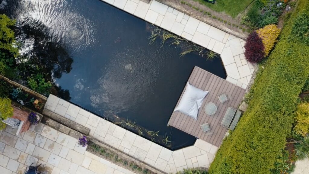 An aerial view of a natural pool and relaxation jetty, taken at the Cobham property
